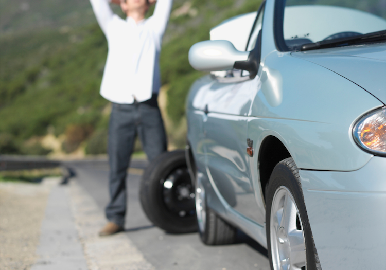 Car flat tire waiting for tow truck